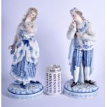 A LARGE PAIR OF 19TH CENTURY GERMAN PORCELAIN FIGURES probably Meissen, painted with blue and white