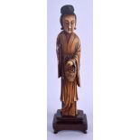 A 19TH CENTURY CHINESE CARVED IVORY FIGURE OF A FEMALE IMMORTAL Qing, modelled holding a basket. Ivo