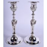 A PAIR OF 1930S ENGLISH SILVER PLATED JOCKEY CANDLESTICKS. 20.5 cm high.
