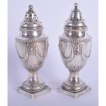 A PAIR OF VICTORIAN SILVER CONDIMENTS. Sheffield 1886. 4.8 oz. 11.5 cm high.