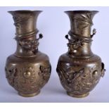 A PAIR OF 19TH CENTURY CHINESE BRONZE VASES decorated with dragons pursuing a flaming pearl. 26 cm h
