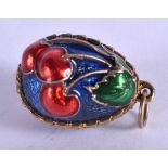 A CONTINENTAL SILVER GILT AND ENAMEL EGG PENDANT. 1.5 cm x 2 cm.