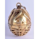 A CONTINENTAL SILVER GILT EGG PENDANT. 3 cm x 2.5 cm.