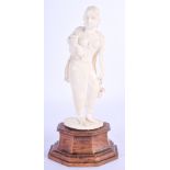 A 19TH CENTURY ANGLO INDIAN CARVED IVORY FIGURE OF A FEMALE modelled holding a flower. Ivory 16 cm x