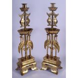 A PAIR OF 19TH CENTURY CHINESE POLISHED BRONZE CANDLESTICKS formed with birds. 45 cm x 11 cm.