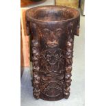 A VINTAGE TRIBAL DAYAK PAPUA NEW GUINEA POT decorated with mask heads. 61 cm x 34 cm.