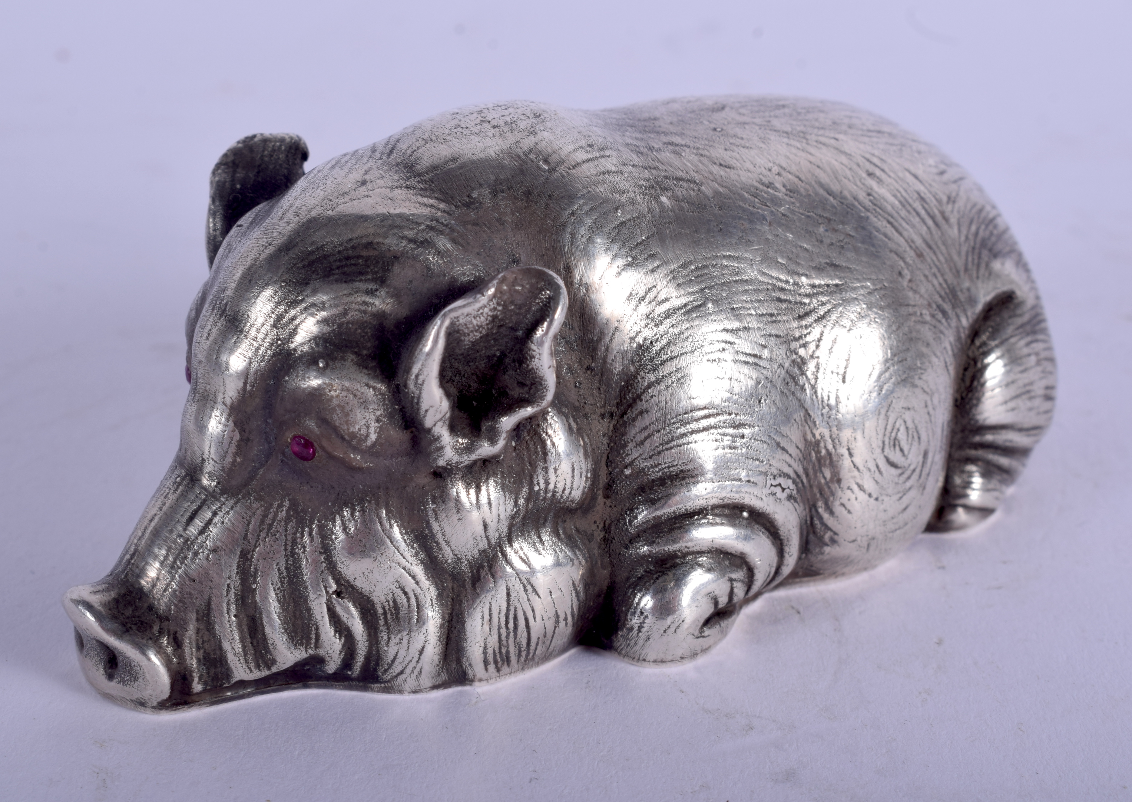 A CONTINENTAL SILVER AND RUBY FIGURE OF A STYLISED HOG. 3.4 oz. 9 cm x 4.5 cm.