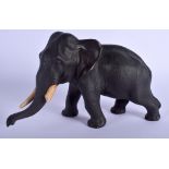 A 19TH CENTURY JAPANESE MEIJI PERIOD BRONZE OKIMONO modelled as a roaming elephant. 26 cm x 18 cm.