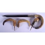 A 19TH CENTURY CONTINENTAL CARVED RHINOCEROS HORN HANDLE together with three other horn handles. Lar