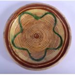 AN 18TH CENTURY DUTCH POTTERY SLIP DECORATED DISH painted with a green flower. 22 cm diameter.