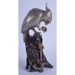 A 19TH CENTURY JAPANESE MEIJI PERIOD SILVER AND BRONZE FIGURE OF A BIRD modelled perched upon a natu