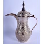 A MIDDLE EASTERN INDO PERSIAN SILVER EWER AND COVER decorated with flowers and scrolling motifs. 17.