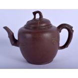 A 19TH CENTURY CHINESE YIXING POTTERY TEAPOT AND COVER moulded with foliage and vines. 16 cm wide.