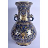 AN EARLY 20TH CENTURY CHINESE TWIN HANDLED BLUE VASE bearing Qianlong marks to base, highlighted in