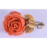 AN ANTIQUE CARVED ROSE CORAL AND YELLOW METAL PENDANT. 2.5 cm x 2.75 cm.