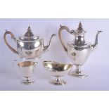 A GEORGE III FOUR PIECE SILVER COFFEE SET bearing twin fist sword armorials. London 1800s (assorted