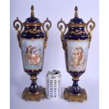 A PAIR OF ANTIQUE FRENCH PORCELAIN VASES AND COVERS probably Sevres, with gilded brass mounts. 40 cm