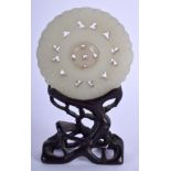 A 19TH CENTURY CHINESE CARVED JADE BI DISC upon a fitted stand. Jade 5.5 cm wide.