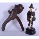A 19TH CENTURY BAVARIAN BLACK FOREST PIPE PLAYER together with a pair of nut crackers. Largest 20 cm