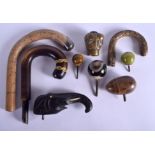 NINE ASSORTED WALKING CANE HANDLES in various forms and sizes. Largest 18 cm x 8 cm. (9)