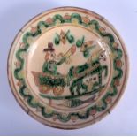 A 19TH CENTURY DUTCH POTTERY SLIP DECORATED BOWL painted with a figure and horse. 21 cm diameter.