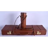 A VINTAGE LEATHER GUN CASE together with a vintage leather army & navy flask. (2)