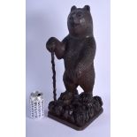 A LARGE 19TH CENTURY BAVARIAN BLACK FOREST FIGURE OF A BEAR modelled standing holding a walking cane