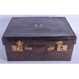 AN ANTIQUE GREEN CROCODILE SKIN LEATHER SUITCASE containing fitted silver bottles etc. 43 cm x 36 cm