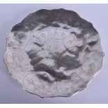 AN EARLY 20TH CENTURY MIDDLE EASTERN SILVER SCALLOPED DISH decorated with foliage. 24.6 oz. 30 cm di