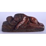 AN ANTIQUE FRENCH CARVED WOOD LACQURED TREEN LION. 15 cm wide.
