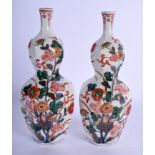 A PAIR OF 18TH CENTURY JAPANESE EDO PERIOD KAKIEMON VASES painted with floral sprays. 17 cm high.