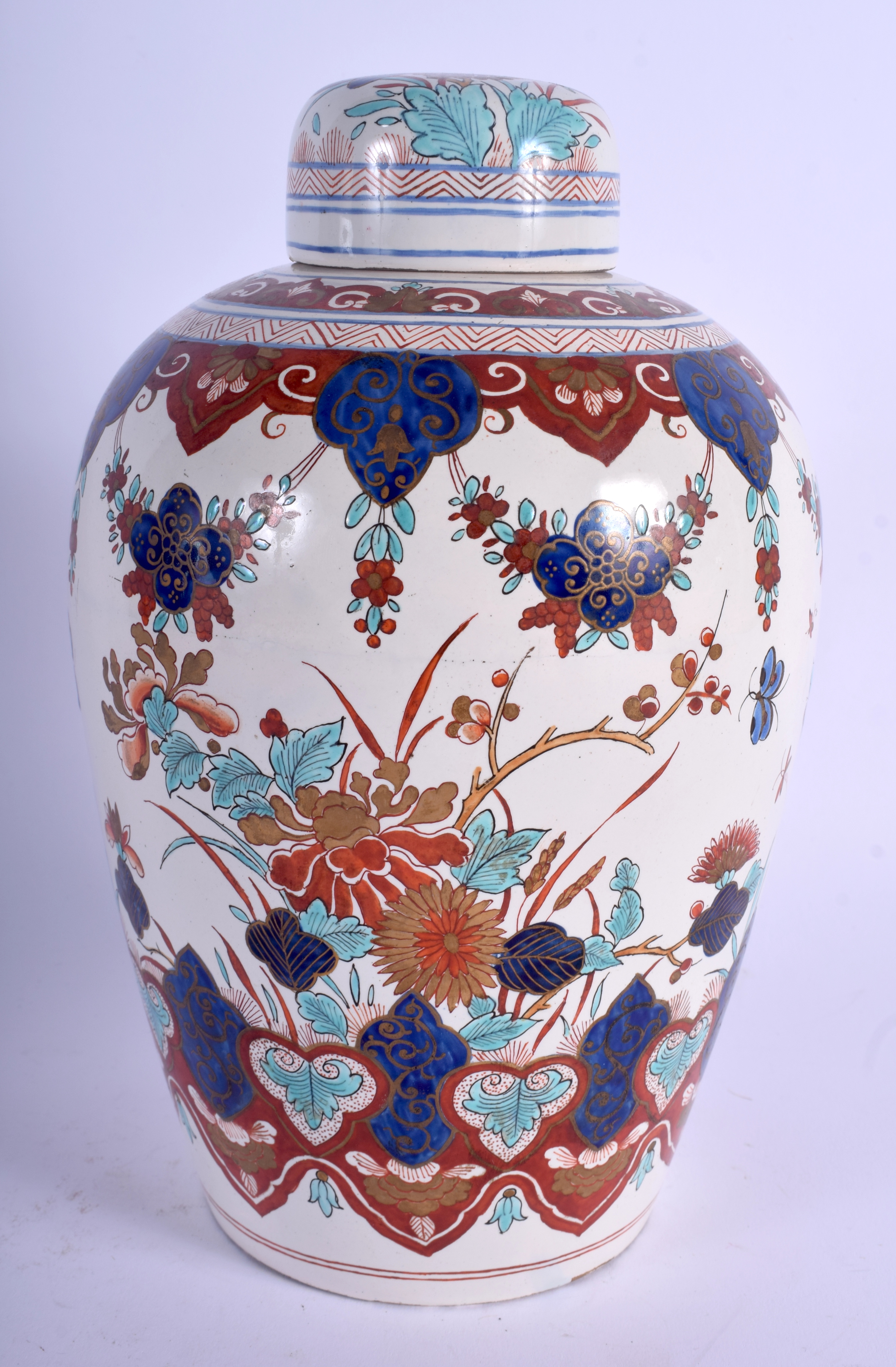 AN 18TH/19TH CENTURY DUTCH DELFT FAIENCE GLAZED JAR AND COVER painted with birds and flowers. 24 cm