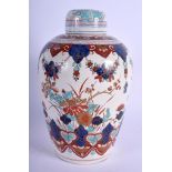 AN 18TH/19TH CENTURY DUTCH DELFT FAIENCE GLAZED JAR AND COVER painted with birds and flowers. 24 cm