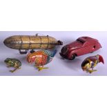 A VINTAGE MARKE TIN PLATE ZEPPELIN together with other tin plate toys. Largest 17 cm wide. (5)