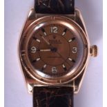 A STYLISH 14CT GOLD ROLEX BUBBLE BACK WRISTWATCH with peach coloured dial. 47.5 grams. 3.5 cm wide.
