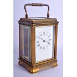 A 19TH CENTURY FRENCH REPEATING BRASS CARRIAGE CLOCK with twin dials. 17.5 cm high inc handle.