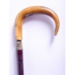 A 19TH CENTURY CONTINENTAL CARVED RHINOCEROS HORN HANDLED WALKING CANE. 88 cm long.