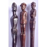 THREE EARLY 20TH CENTURY AFRICAN TRIBAL WALKING CANES one with serpent shaft. Largest 88 cm long. (3