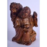 A 19TH CENTURY CHINESE CARVED SOAPSTONE FIGURE OF AN IMMORTAL Qing, modelled beside a dragon. 9 cm x
