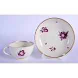 Worcester teacup and saucer painted with purple fruit. 13 cm wide.