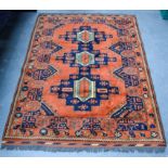 A LARGE MIDDLE EASTERN ORANGE GROUND RUG decorated with motifs. 186 cm x 42 cm.