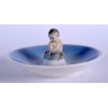 A ROYAL COPENHAGEN PORCELAIN DISH with seated mermaid. 13.5 cm wide.