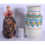 A LARGE CONTINENTAL POTTERY BEAR BATING JUG together with a large Faience vase. Largest 35 cm high.