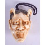 A LOVELY 19TH CENTURY JAPANESE MEIJI PERIOD CARVED IVORY MASK NETSUKE modelled as a demonic male. 3.