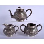 A 19TH CENTURY CHINESE EXPORT SILVER THREE PIECE TEA SET by Wing Nam & Co, decorated with dragons. 9