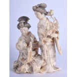 A 19TH CENTURY JAPANESE MEIJI PERIOD CARVED IVORY OKIMONO modelled as two geisha and a child. 9 cm x