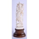A 19TH CENTURY INDIAN IVORY FIGURE OF A BUDDHISTIC DEITY upon a hardwood base. Ivory 16 cm high.