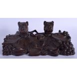 A 19TH CENTURY BAVARIAN BLACK FOREST CARVED WOOD DOUBLE HEADED INKWELL modelled as two pugs dogs. 25