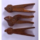THREE ANTIQUE SWEDISH CARVED BOXWOOD TREEN NUT CRACKERS in various forms. Largest 18 cm long. (3)