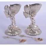 A FINE PAIR OF VICTORIAN SILVER MERMAID SALTS by Smith & Nicholson, with matching spoons. London 185